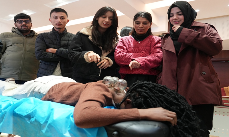 International students experience traditional Chinese medicines' cupping therapy at a teaching and research base at Southwest University in Chongqing Municipality on Novemeber 21, 2024. Photo: VCG