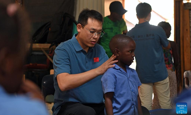 A member of the Chinese medical team conducts spine examination for a child at the Frans Nambinga Arts and Training Center in Windhoek, Namibia, Nov. 20, 2024. (Xinhua/Chen Cheng)