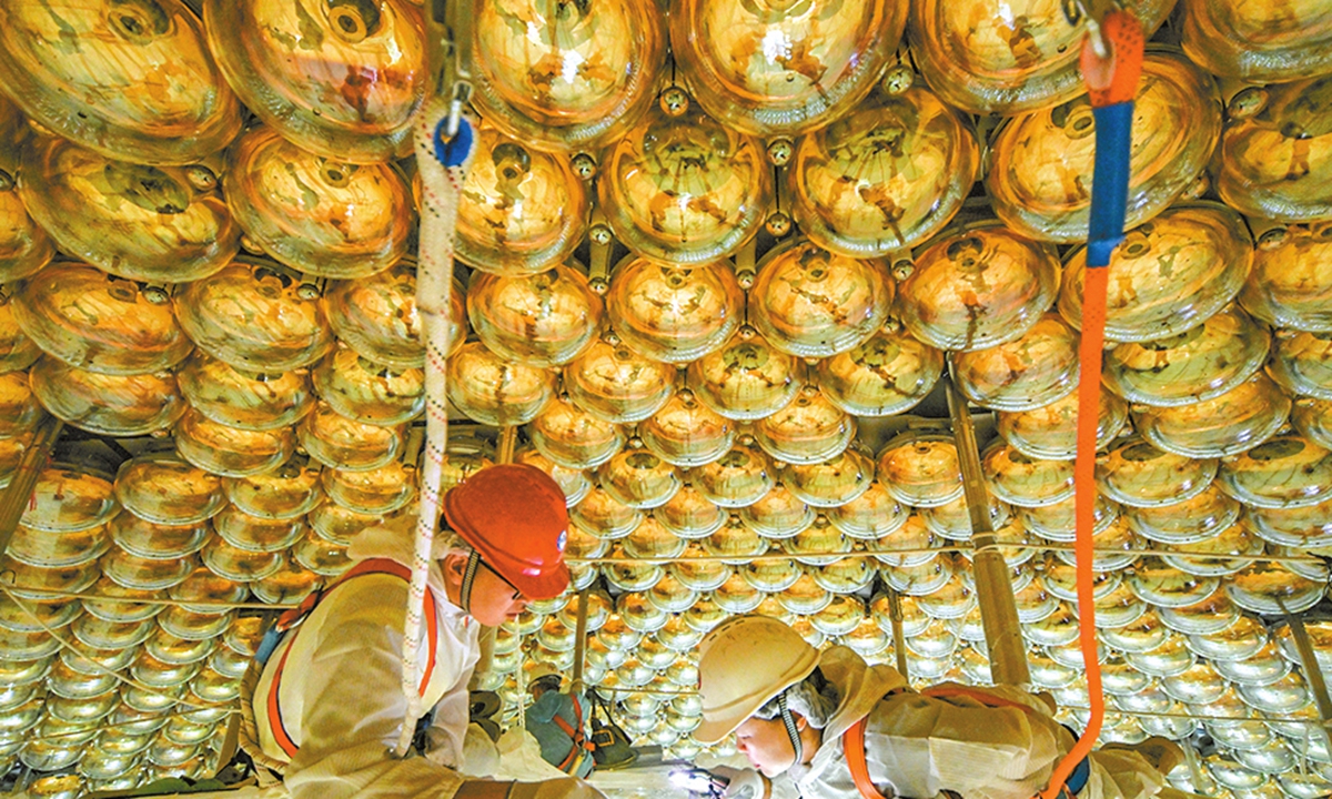 Working staff check the installation of JUNO's acrylic spheres. Photo: Courtesy of IHEP
