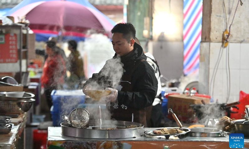 A stall owner prepares breakfast for customers at a morning market in Chengtuan Town of Liuzhou, south China's Guangxi Zhuang Autonomous Region, Nov. 20, 2024. With various choices, delicious taste and affordable price, breakfast at the morning market in Chengtuan Town is deeply loved by local residents. It has also become popular on the internet, attracting more and more tourists to experience its unique. (Xinhua/Huang Xiaobang)