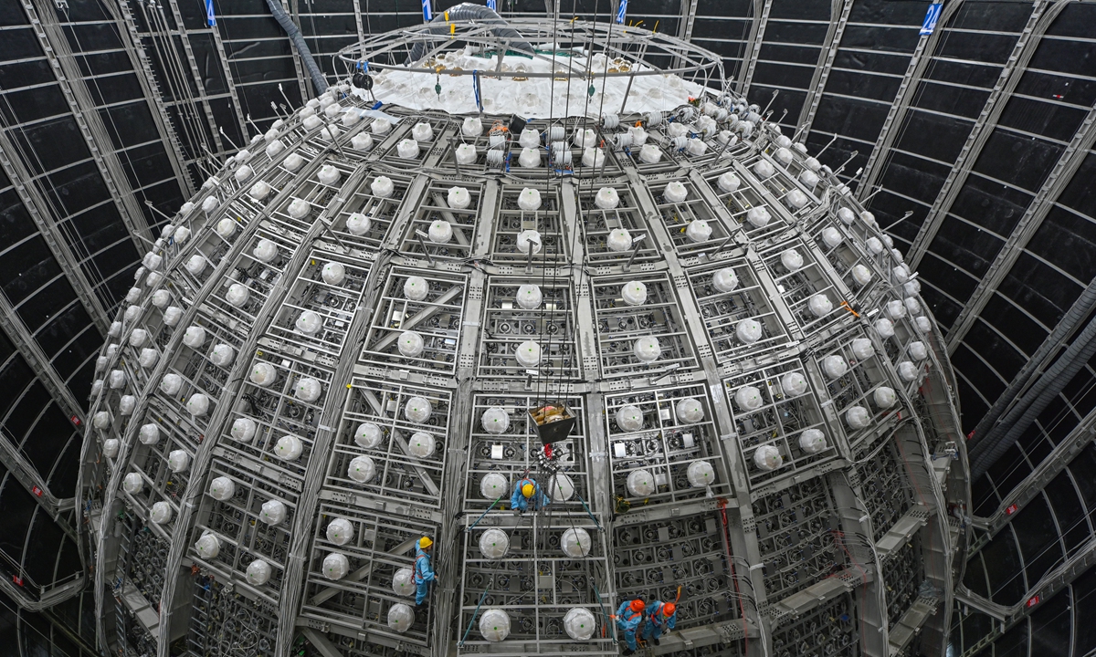 Working staff install equipment into the JUNO veto detector system which is designed for cosmic muon detection and background reduction. Photo: Courtesy of IHEP