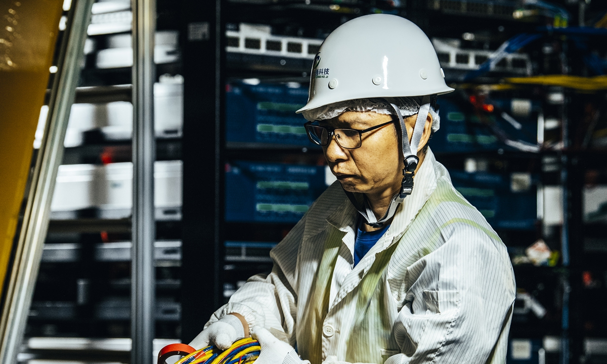 A technician works at the JUNO construction site. Photo: VCG
