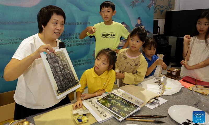 Feng Yingqiao teaches Chinese calligraphy to children at the Chinese Cultural Center in Dar es Salaam, Tanzania, on Nov. 8, 2024. (Photo: Xinhua)