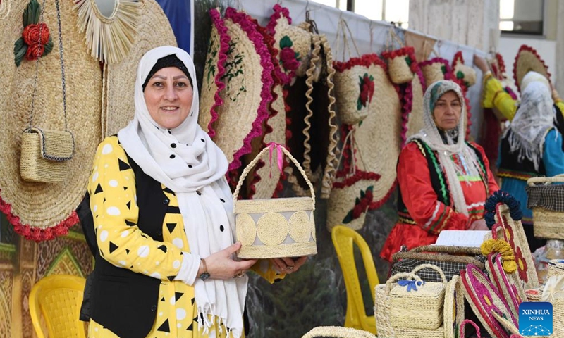 A woman shows straw handicraft in Rasht, Iran, Nov. 19, 2024. (Xinhua/Shadati)