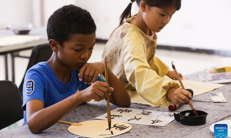 Children learn Chinese calligraphy at the Chinese Cultural Center in Dar es Salaam, Tanzania, on Nov. 8, 2024. (Photo: Xinhua)