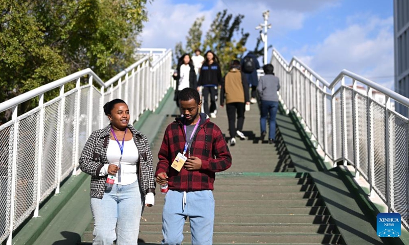 Kalkidan (L) walks downstairs with her schoolmate at the Tianjin University of Technology and Education in Tianjin, north China, Nov. 22, 2024. (Photo: Xinhua)