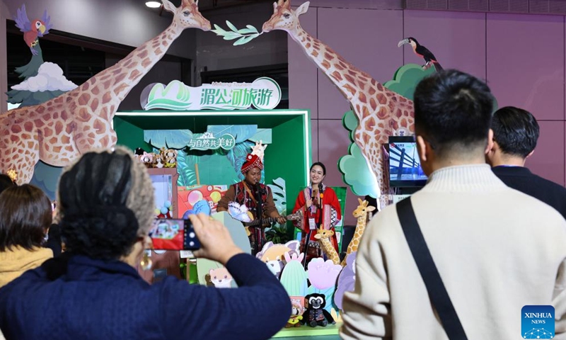 Visitors watch performances at the booth of Mekong Tourism during the China International Travel Mart 2024 in east China's Shanghai, Nov. 22, 2024. The China International Travel Mart 2024, organized by the Ministry of Culture and Tourism, kicked off Friday in Shanghai, bringing together exhibitors from over 80 countries and regions. The three-day fair has attracted more than 1,000 international exhibitors and nearly 600 travel agencies, along with over 600 offline buyer-seller meetings, according to the organizers. (Xinhua/Fang Zhe)