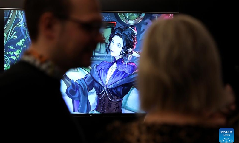 People watch a short video of Lord of the Mysteries during the inclusion event of ten online Chinese novels at the British Library in London, Britain, on Nov. 21, 2024. (Xinhua/Li Ying)