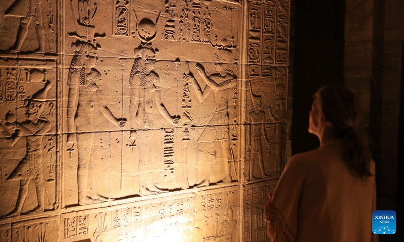 A tourist views the relief painting in the Philae temple complex in Aswan, Egypt, Nov. 22, 2024. (Photo: Xinhua)