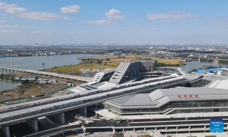 An aerial drone photo taken in Suzhou, east China's Jiangsu Province on Nov. 23, 2024 shows a bullet train pulling into the Suzhou South Railway Station under construction along new high-speed rail line connecting Shanghai Municipality with the provinces of Jiangsu and Zhejiang in east China.  (Photo: Xinhua)