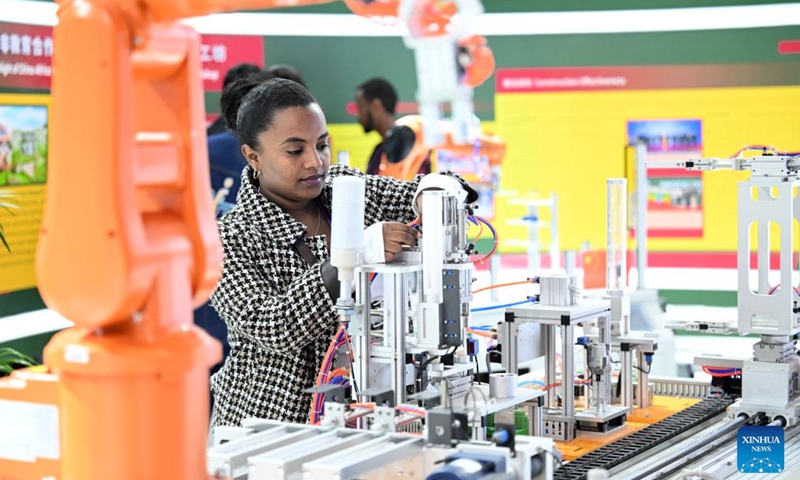 Kalkidan checks equipment displayed at the booth of Ethiopian Luban Workshop during the 2024 World Vocational and Technical Education Development Conference in Tianjin, north China, Nov. 22, 2024. (Photo: Xinhua)