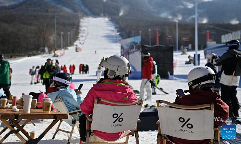 Skiers take a rest outside a cafe at the Beidahu Ski Resort in Jilin City, northeast China's Jilin Province, on Nov. 23, 2024. Following the recent snowfall and drop in temperature, a new ski season has kicked off in northeast China's Jilin Province. (Photo: Xinhua)