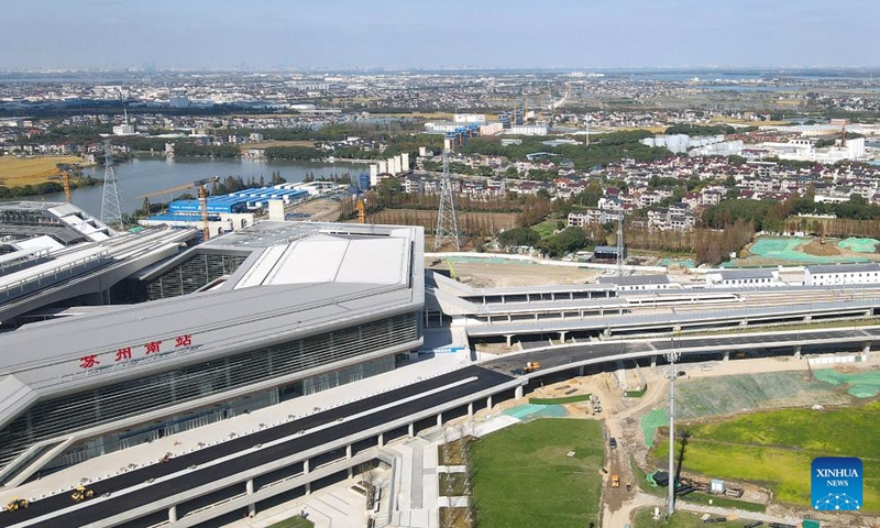 An aerial drone photo taken in Suzhou, east China's Jiangsu Province on Nov. 23, 2024 shows a bullet train leaving the Suzhou South Railway Station under construction along new high-speed rail line connecting Shanghai Municipality with the provinces of Jiangsu and Zhejiang in east China.  (Photo: Xinhua)