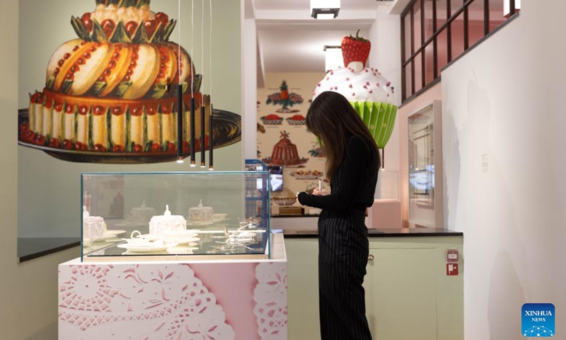 A woman takes notes during a press preview of the exhibition Grand Dessert - The History of Dessert at the Kunstmuseum in The Hague, the Netherlands, on Nov. 22, 2024. Showcasing a rich array of desserts through centuries of culinary culture, the exhibition will be open to the general public from Nov. 23, 2024 to April 6, 2025. (Photo by Sylvia Lederer/Xinhua)