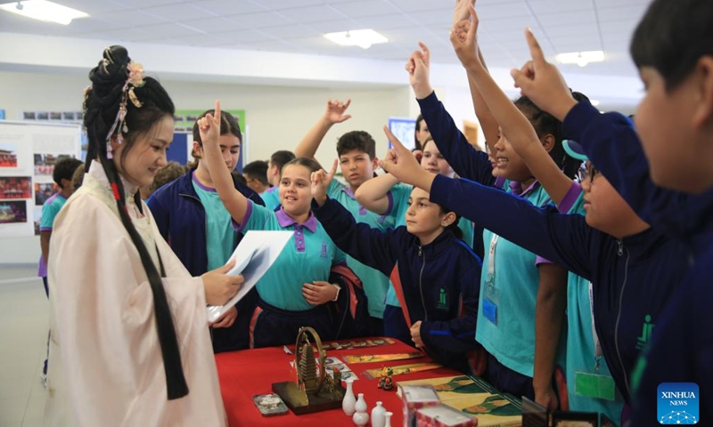 Students participate in interactive activities during the Confucius-themed photo exhibition in Qormi, Malta, on Nov. 22, 2024. (Xinhua/Chen Wenxian)