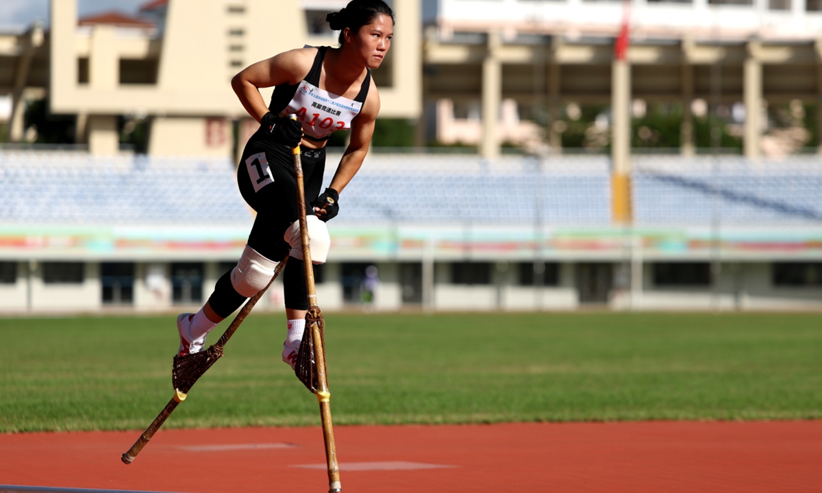 An athlete competes in the women's 400-meter stilt racing competition at the 12th National Traditional Games of Ethnic Minorities in Sanya, Hainan Province on November 25, 2024. Held every four years, this historic event has become a grand festival for all ethnic groups to celebrate their shared heritage and foster unity. Photo: VCG