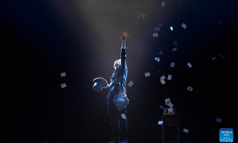 An actor performs magic tricks during an acrobatic show in Beijing, capital of China, Nov. 23, 2024. A two-day acrobatic show kicked off in Beijing on Friday, featuring performances staged by outstanding young acrobatic talents across China. (Xinhua/Cai Yang)