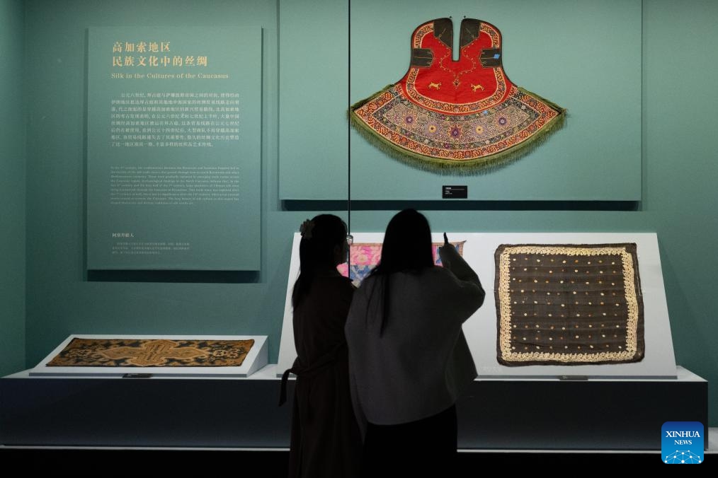 Visitors view exhibits during an exhibition titled Cocoon of Traditions: Silk in the National Cultures of Eurasia at Hubei Provincial Museum in Wuhan, central China's Hubei Province, Nov. 22, 2024. The exhibition, which opened here on Nov. 22, showcases 283 pieces of silk textiles dating back from the 19th century to the first half of the 20th century from the Russian Museum of Ethnography. (Xinhua/Xiao Yijiu)