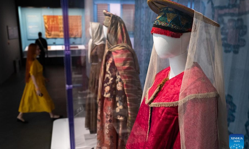 People visit an exhibition titled Cocoon of Traditions: Silk in the National Cultures of Eurasia at Hubei Provincial Museum in Wuhan, central China's Hubei Province, Nov. 22, 2024. The exhibition, which opened here on Nov. 22, showcases 283 pieces of silk textiles dating back from the 19th century to the first half of the 20th century from the Russian Museum of Ethnography. (Xinhua/Xiao Yijiu)