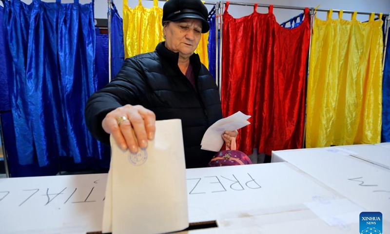 A woman votes during the first round of the presidential elections at a polling station in Bucharest, Romania, Nov. 24, 2024. Romanians headed to the polls Sunday for the first round of the presidential election, choosing from 14 candidates to lead the country for the next five years. (Photo by Cristian Cristel/Xinhua)