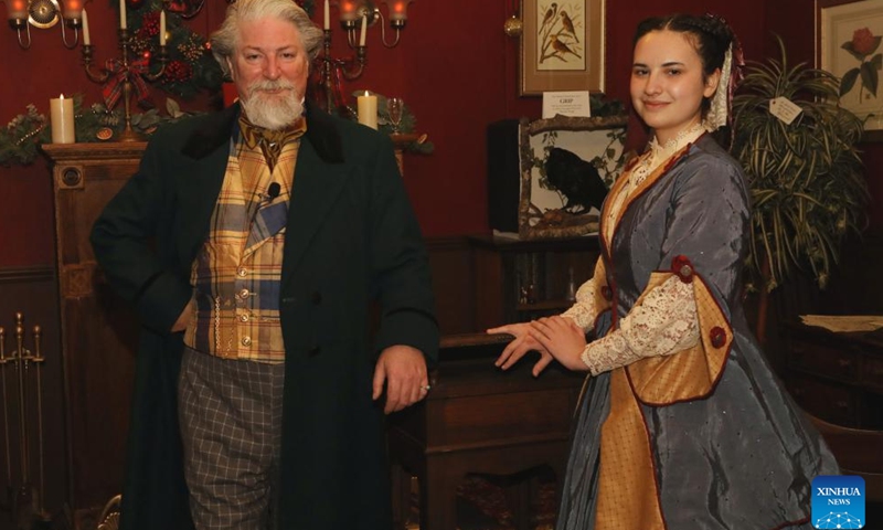 An actor (L) plays Charles Dickens at the Great Dickens Christmas Fair in San Francisco, the United States, Nov. 23, 2024. The Great Dickens Christmas Fair, which was first held in 1970, opened in San Francisco on Saturday. The fair is aimed at attracting people to enjoy the culture of the Victorian era by recalling the characters and scenes in the works of British novelist Charles Dickens. (Photo by Liu Yilin/Xinhua)