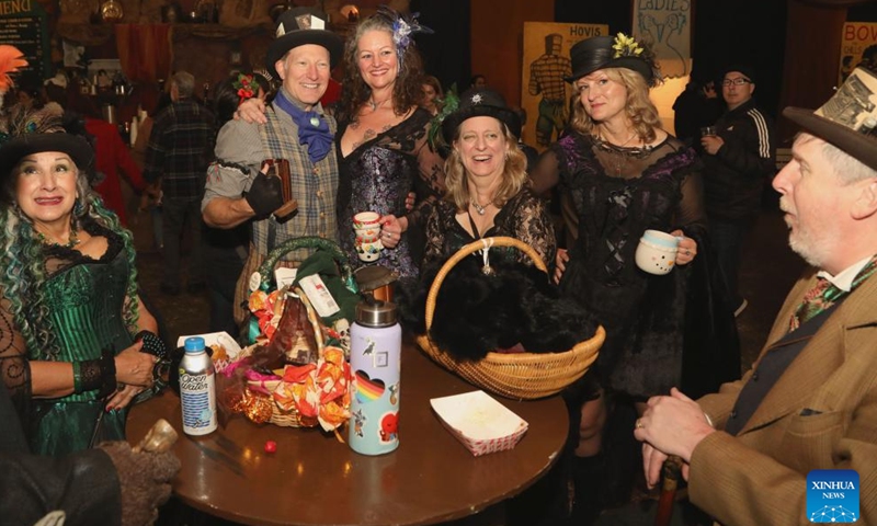 People wearing costumes of the Victorian era take part in the Great Dickens Christmas Fair in San Francisco, the United States, Nov. 23, 2024. The Great Dickens Christmas Fair, which was first held in 1970, opened in San Francisco on Saturday. The fair is aimed at attracting people to enjoy the culture of the Victorian era by recalling the characters and scenes in the works of British novelist Charles Dickens. (Photo by Liu Yilin/Xinhua)