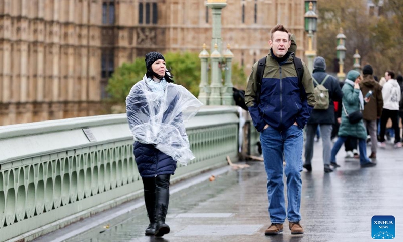 People walk on the Westminster Bridge in London, Britain, Nov. 23, 2024. Strong winds, heavy rain, and flooding brought by Storm Bert caused travel disruption and power outages across Britain over the weekend, leaving three men dead. (Xinhua)