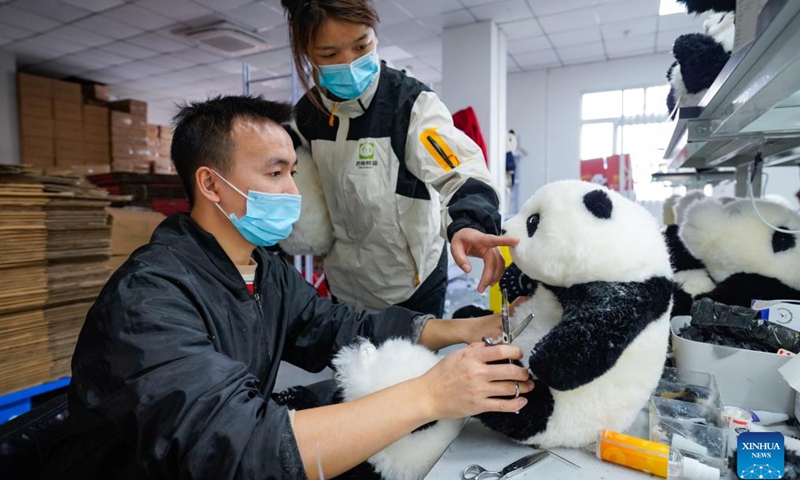 A quality inspector (R) advises a stylist on the modification of a stuffed panda toy at a workshop of SeeU Panda in Chengdu, southwest China's Sichuan Province, Nov. 21, 2024.(Xinhua/Shen Bohan)