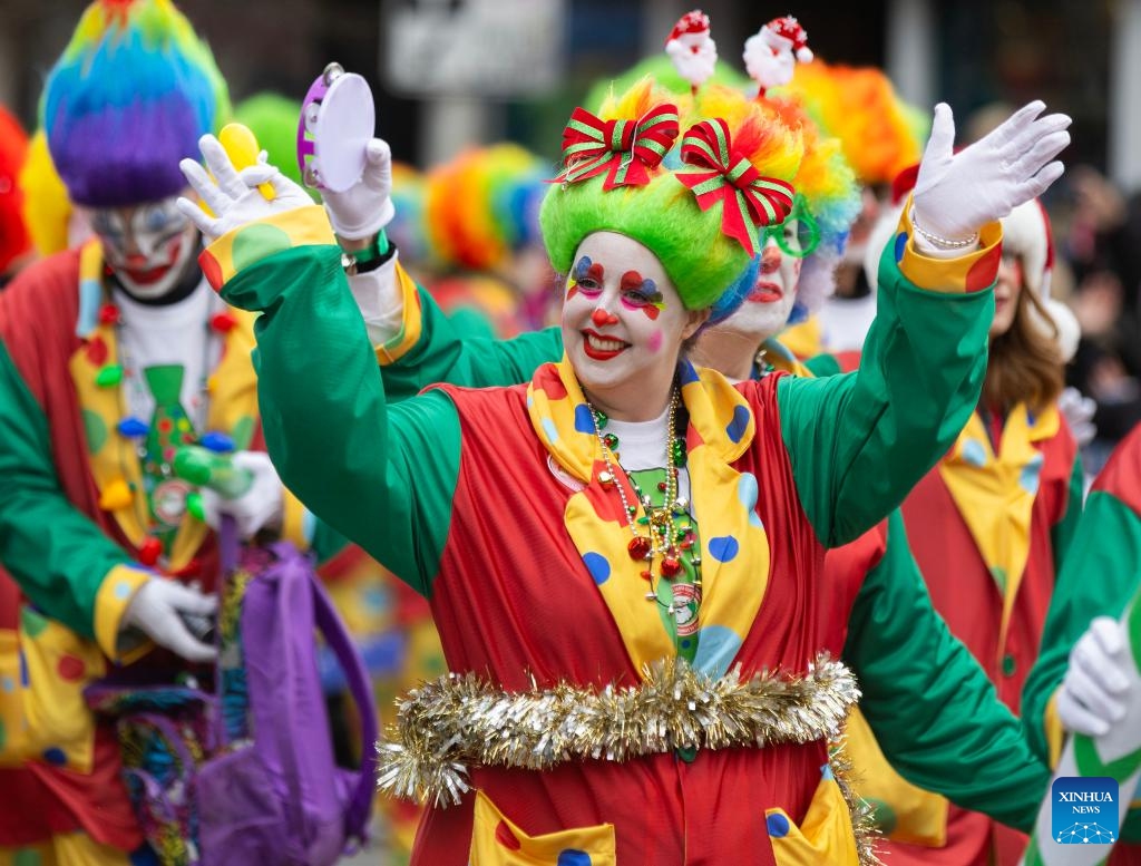 Dressed-up people wave to crowds during the 2024 Toronto Santa Claus Parade in Toronto, Canada, on Nov. 24, 2024. (Photo by Zou Zheng/Xinhua)