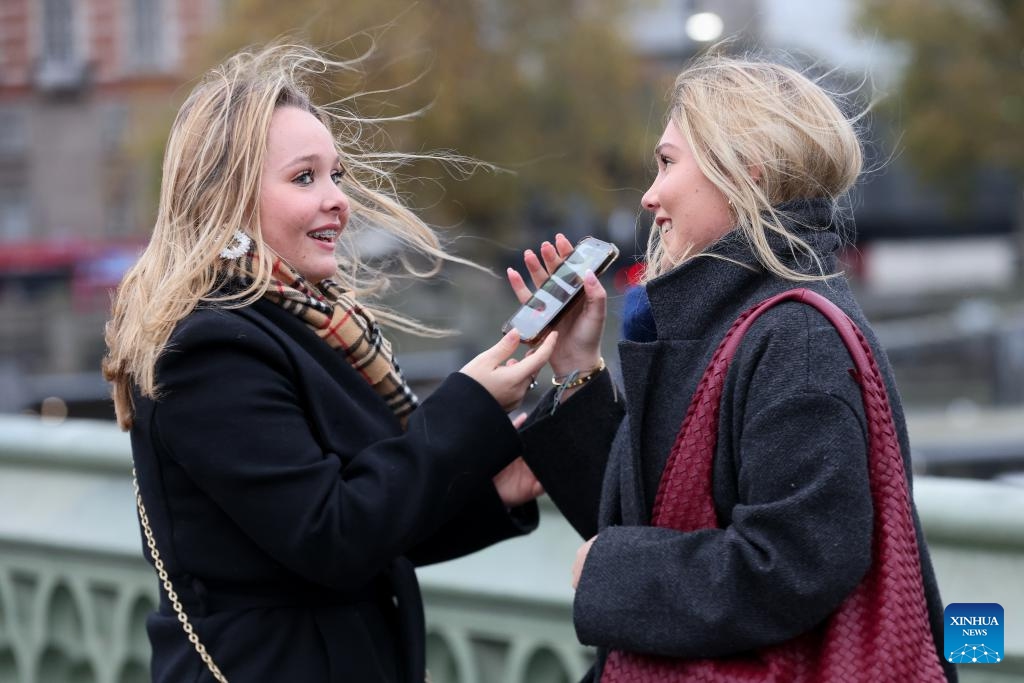 People stand on the Westminster Bridge in London, Britain, Nov. 23, 2024. Strong winds, heavy rain, and flooding brought by Storm Bert caused travel disruption and power outages across Britain over the weekend, leaving three men dead. (Xinhua)