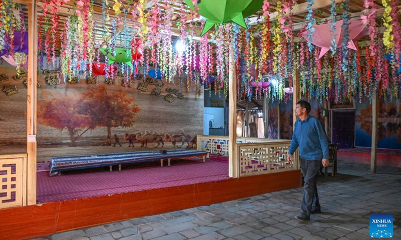 This photo taken on Nov. 7, 2024 shows a villager walking at his homestay in Daliyabuyi Village, Yutian County of northwest China's Xinjiang Uygur Autonomous Region.  (Xinhua/Chen Shuo)