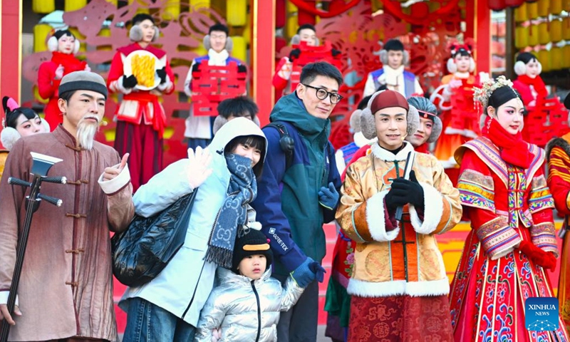 Tourists pose for photos with performers at an immersive performing arts town in Xixia District of Yinchuan, northwest China's Ningxia Hui Autonomous Region, Nov. 25, 2024. (Photo: Xinhua)