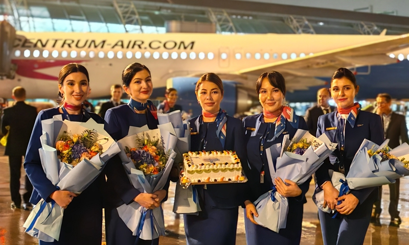 A Centrum Air flight crew from Uzbekistan poses for a photo in front of an aircraft on the carrier's inaugural flight from Tashkent to Guangzhou, South China's Guangdong Province. The flight successfully landed at Guangzhou Baiyun International Airport on November 25, 2024, marking the company's first passenger route to China. Photo: VCG