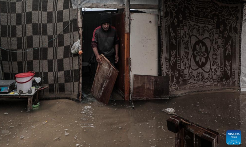 A man is seen inside a flooded tent after heavy rain in the Mawasi area of Khan Younis, southern Gaza Strip, on Nov. 25, 2024. UN humanitarians said on Monday they and their partners have been evaluating flood damage in a response to multiple sites for displaced Gazans hit by heavy weekend rainfall. (Photo: Xinhua)