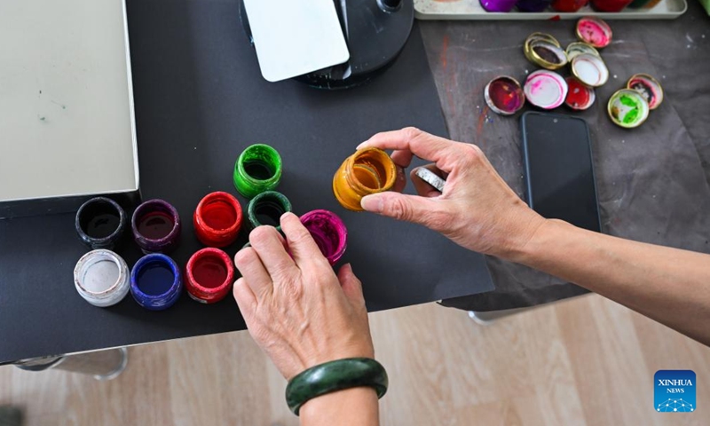 Li Xintong prepares paints for an Ebru creation in Istanbul, Türkiye, Nov. 5, 2024. Ebru, or the Turkish art of paper marbling, is a traditional painting art. To create an Ebru, the artist will have to paint on water and then transfer this painting onto paper. In 2014, Ebru was officially listed as a UNESCO World Intangible Culture Heritage. (Photo: Xinhua)