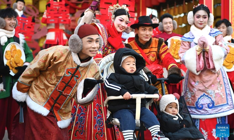 Tourists pose for photos with performers at an immersive performing arts town in Xixia District of Yinchuan, northwest China's Ningxia Hui Autonomous Region, Nov. 25, 2024.(Photo: Xinhua)