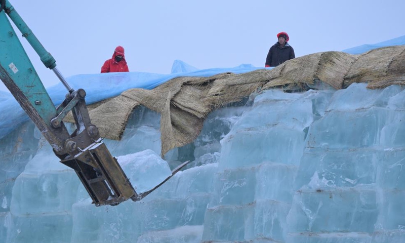 An engineering vehicle fetches ice cubes to be used in the construction of the 26th Harbin Ice-Snow World in Harbin, northeast China's Heilongjiang Province, Nov. 26, 2024. (Photo: Xinhua)