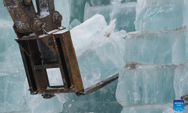 An engineering vehicle fetches ice cubes to be used in the construction of the 26th Harbin Ice-Snow World in Harbin, northeast China's Heilongjiang Province, Nov. 26, 2024. The Harbin Ice-Snow World is a renowned seasonal theme park in Harbin which enjoys great popularity every winter. This year, the park will highlight the upcoming Asian Winter Games, a sports event scheduled for February 2025 in Heilongjiang Province. (Photo: Xinhua)