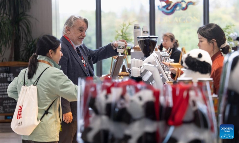 Guests look at creative cultural products themed on giant pandas during the Global Panda Partners 2024 conference in Chengdu, southwest China's Sichuan Province, Nov. 26, 2024. The event opened here on Tuesday with the theme Harmonious Coexistence Between Man and Nature.  (Photo: Xinhua)