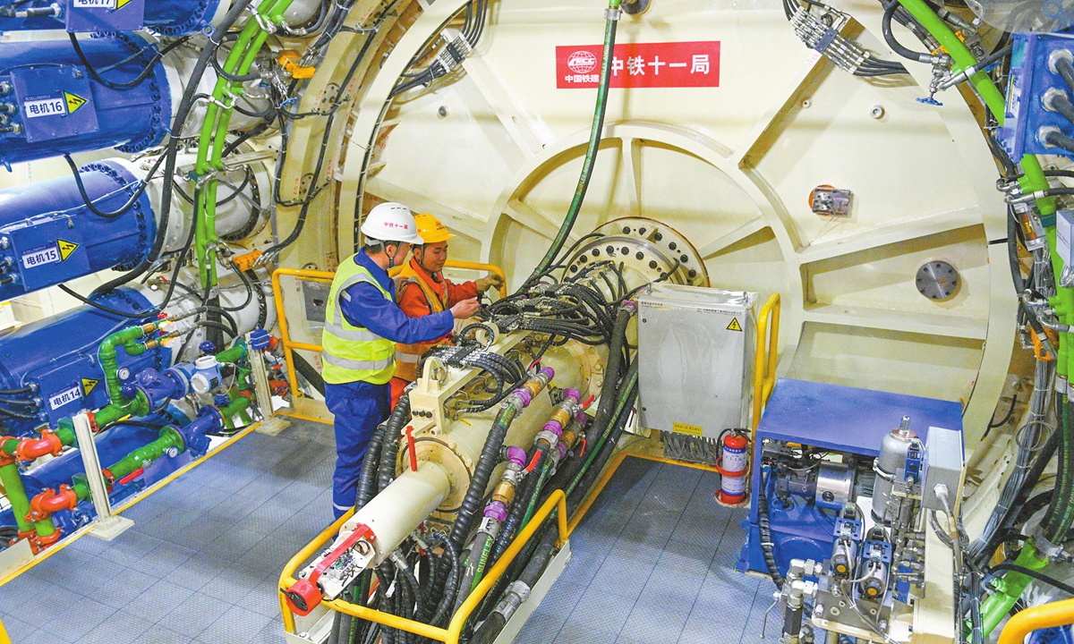 Workers inspect a tunnel boring machine in Chengdu, Southwest China's Sichuan Province on November 27, 2024. The 14-meter diameter 