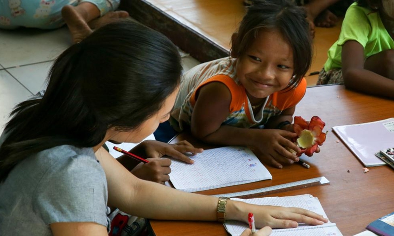 A local teacher tutors street kids at a monastery compound in Yangon, Myanmar, Nov. 24, 2024. (Photo: Xinhua)