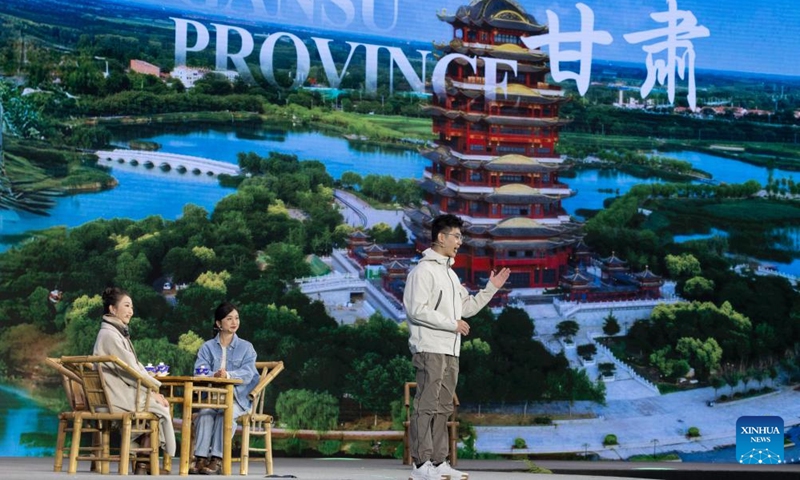 Young people from the provinces of Sichuan, Gansu and Shaanxi promote tourism resources during the Global Panda Partners 2024 conference in Chengdu, southwest China's Sichuan Province, Nov. 26, 2024. The event opened here on Tuesday with the theme Harmonious Coexistence Between Man and Nature. (Photo: Xinhua)