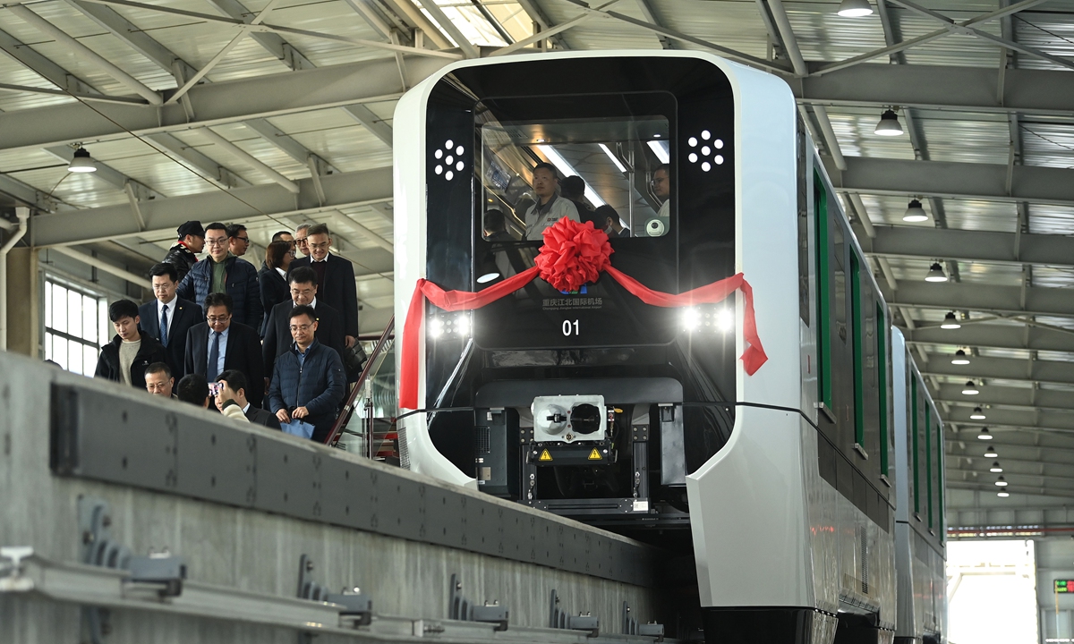 Guests experience a monorail transit vehicle at the Jiangbei International Airport of Southwest China's Chongqing on November 28, 2024. The monorail will be put into use connecting two terminals at the airport. The vehicle is equipped with a self-driving system at the highest level of automation and features an independent power unit. This will be the first time that such a vehicle is used at an airport. Photo: VCG