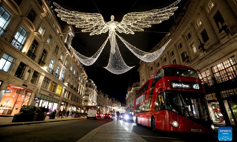 A double-decker bus runs on Regent Street decorated with lights in central London, Britain, on Nov. 27, 2024. (Xinhua/Li Ying)