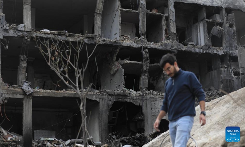 A Lebanese returnee is seen in front of a ruined building in Nabatieh, Lebanon, on Nov. 28, 2024. (Photo: Xinhua)