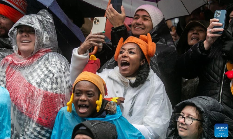 Spectators watch the 2024 Macy's Thanksgiving Day Parade in New York, the United States, on Nov. 28, 2024. (Photo by Michael Nagle/Xinhua)