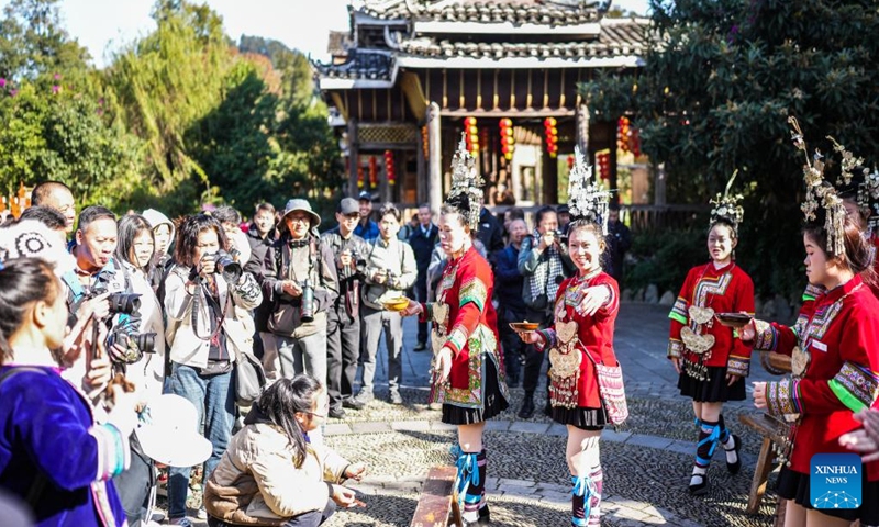 People of Dong ethnic group invite tourists to drink liquor as they celebrate Dongnian festival in Zhaoxing Dong village of Liping County in Qiandongnan Miao and Dong Autonomous Prefecture, southwest China's Guizhou Province, Nov. 29, 2024. (Photo: Xinhua)