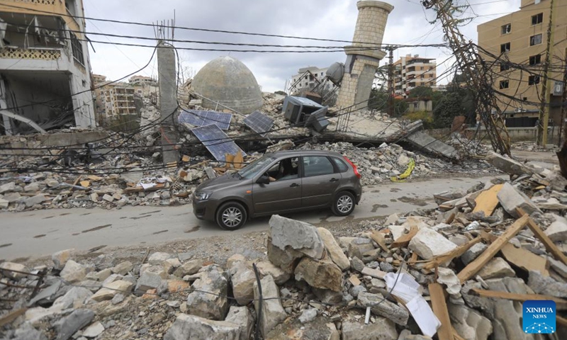 A Lebanese woman drives a car among rubble on her way home in Nabatieh, Lebanon, on Nov. 28, 2024. (Photo: Xinhua)