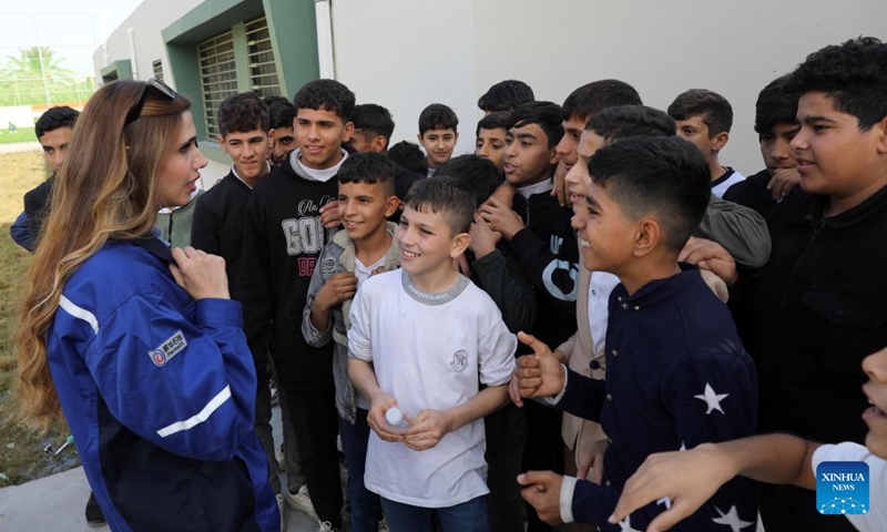 Students talk with an engineer of the Chinese firm Zhenhua Oil in the al-Musahama Model School in Baghdad, Iraq, Nov. 17, 2024.  (Photo: Xinhua)