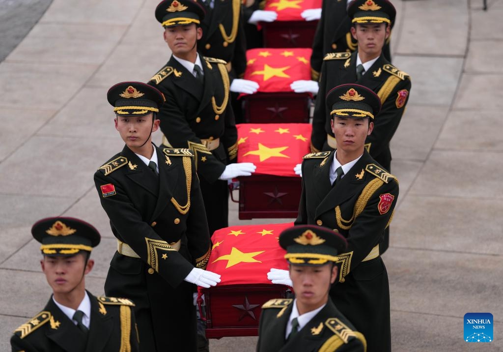 Guards of honor escort the caskets of the fallen Chinese People's Volunteers (CPV) martyrs during a burial ceremony at the CPV martyrs' cemetery in Shenyang, northeast China's Liaoning Province, Nov. 29, 2024. The remains of 43 Chinese People's Volunteers (CPV) soldiers who lost their lives during the War to Resist U.S. Aggression and Aid Korea (1950-1953) were laid to rest on Friday in Shenyang, capital of northeast China's Liaoning Province. (Xinhua/Li Gang)